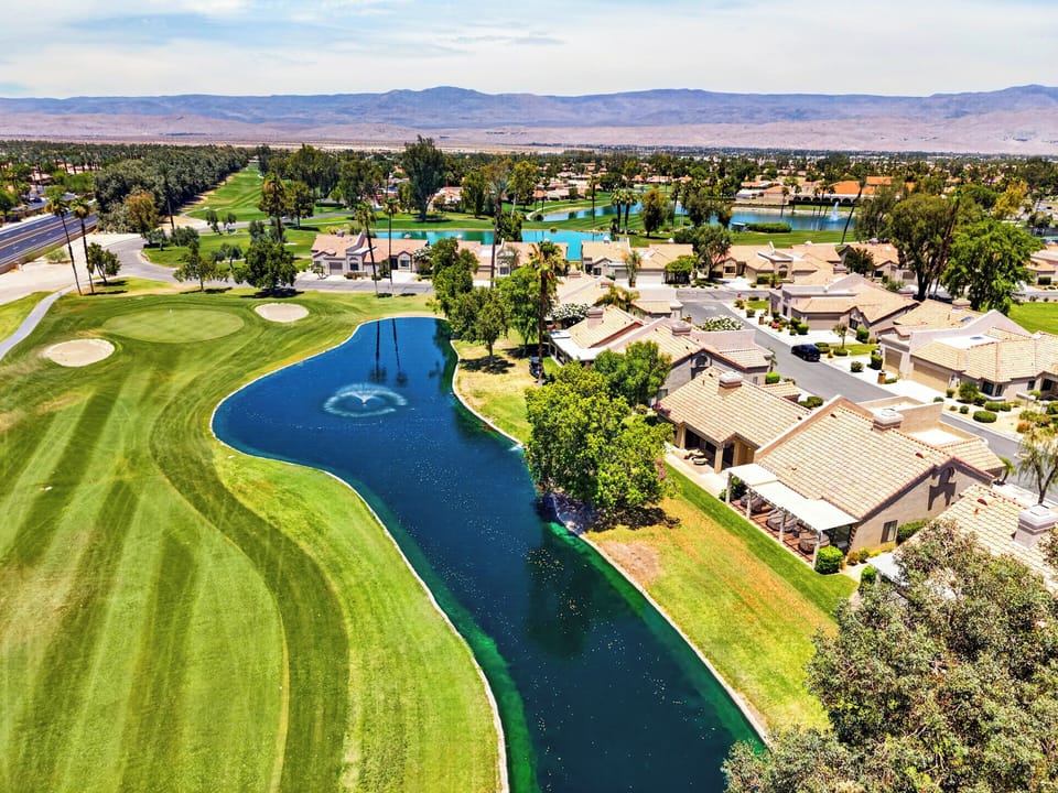 Overhead, look at the expansive community water feature and winding golf course fairways that step away from the property.
