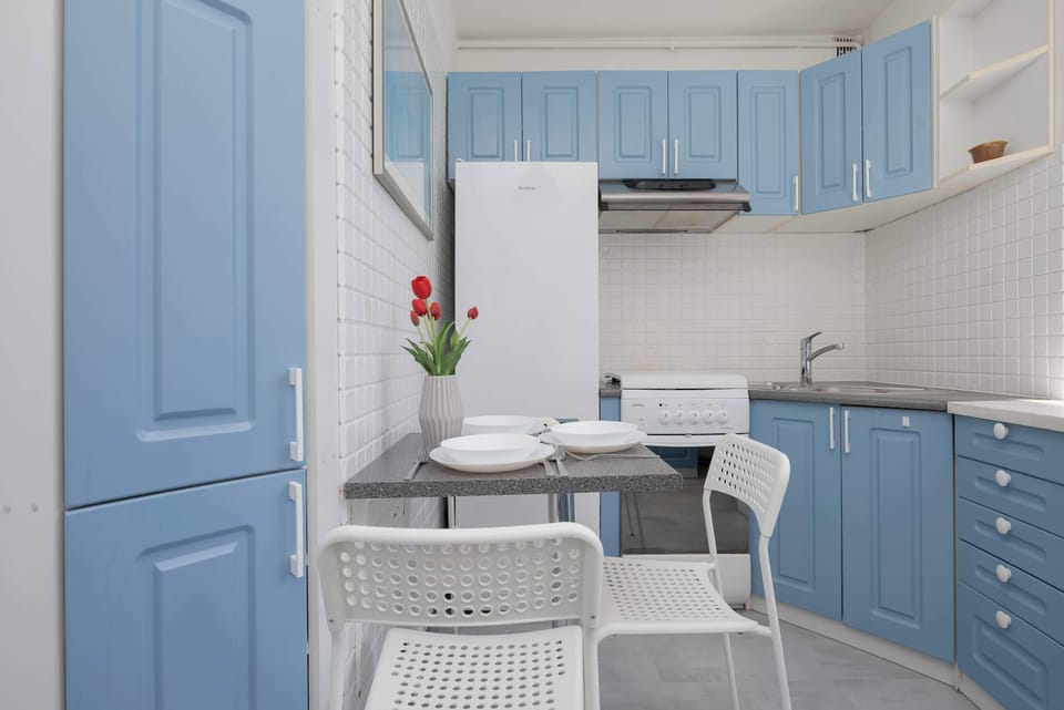 Fully equipped separate kitchen with modern appliances, ample storage space, and a dining area.
