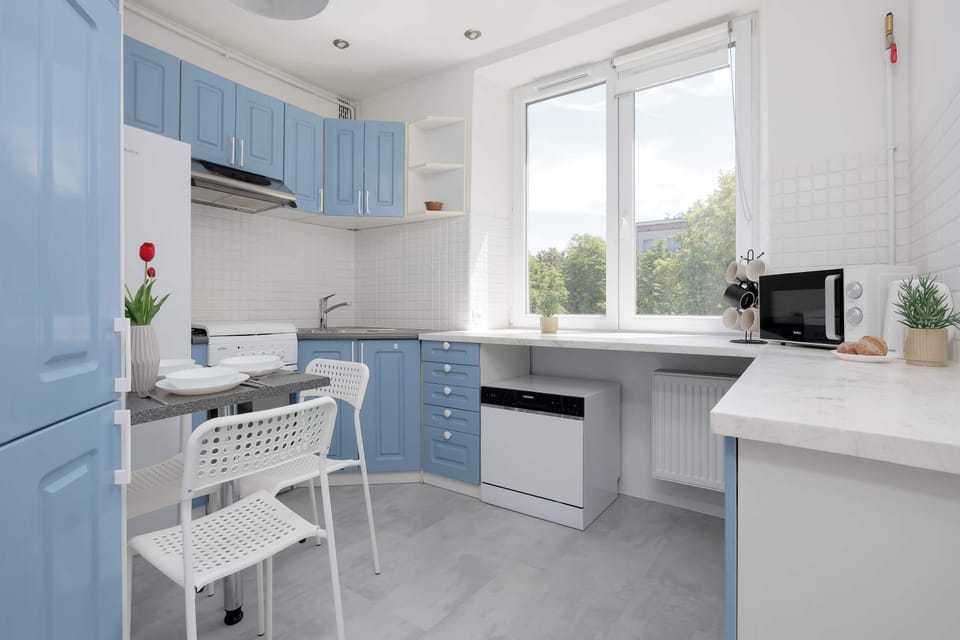 Fully equipped separate kitchen with modern appliances, ample storage space, and a dining area.