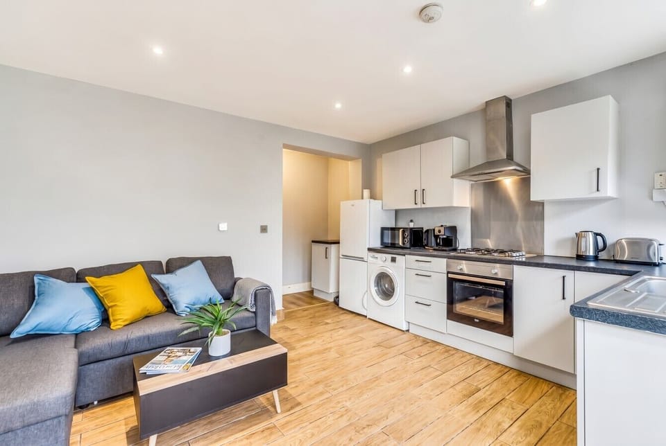 Cosy sofa corner beside the fully equipped kitchen