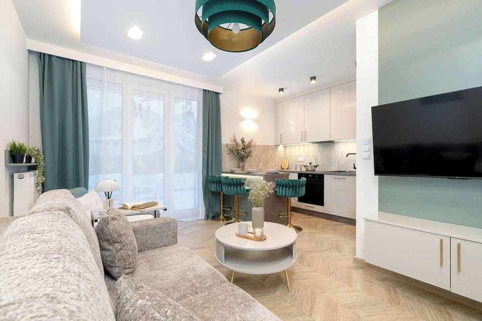 The living area has a modern look and comfortable furniture.