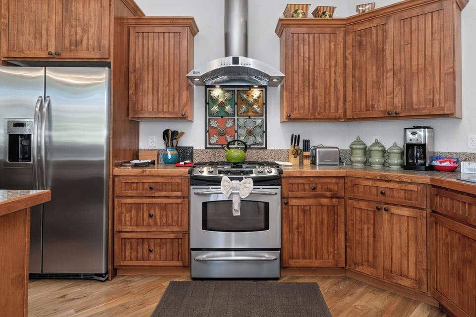 Your fully-equipped kitchen invites culinary adventures with warm wood cabinetry, modern appliances, and plenty of counter space for preparing memorable meals together.