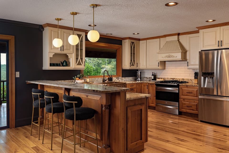 {Kitchen} Cook, gather, and stay connected in the open kitchen with a large island, bar seating, and plenty of prep space for group meals.