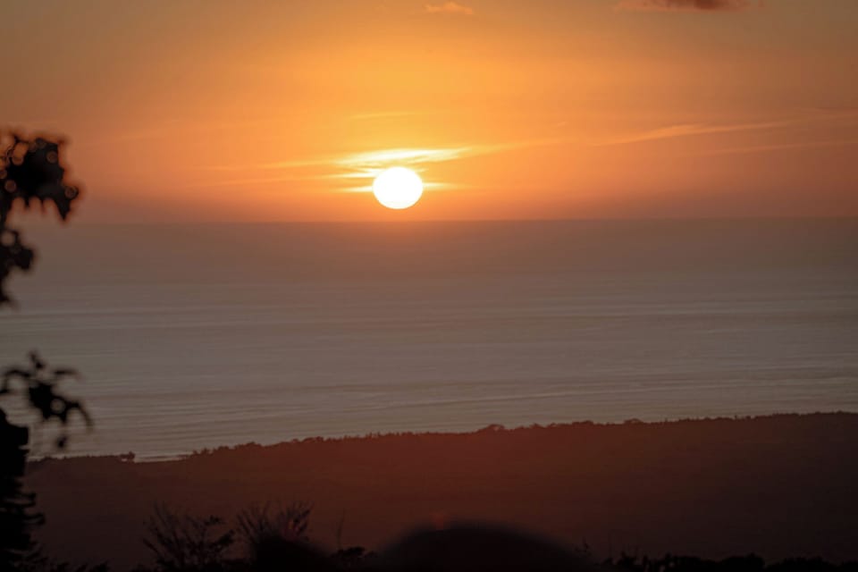 Golden Pacific sunset stretching across the horizon from Casa Infinity