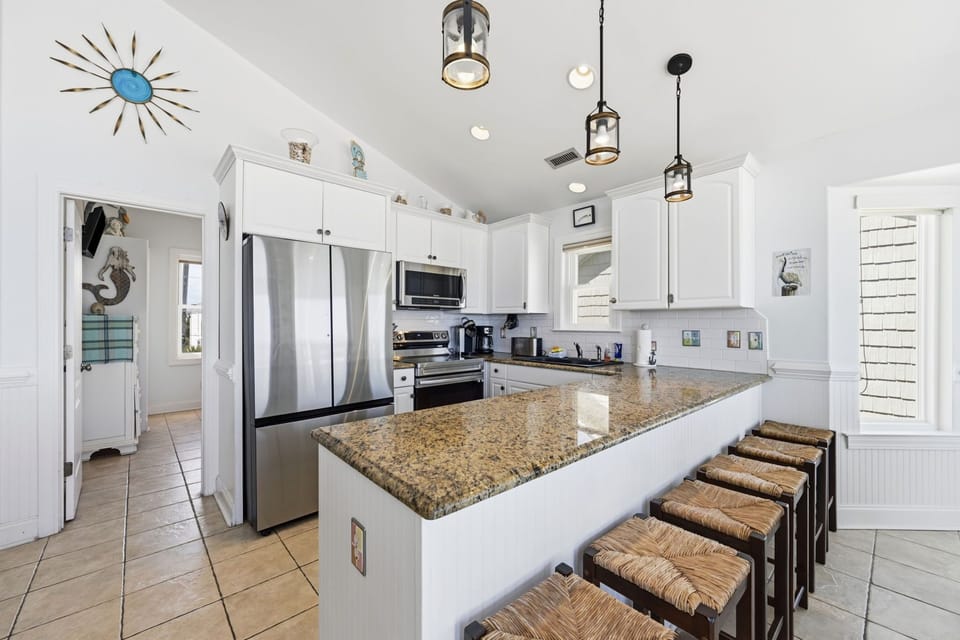 Clean coastal kitchen with everything you need, nothing you don’t, and views that keep you cooking
