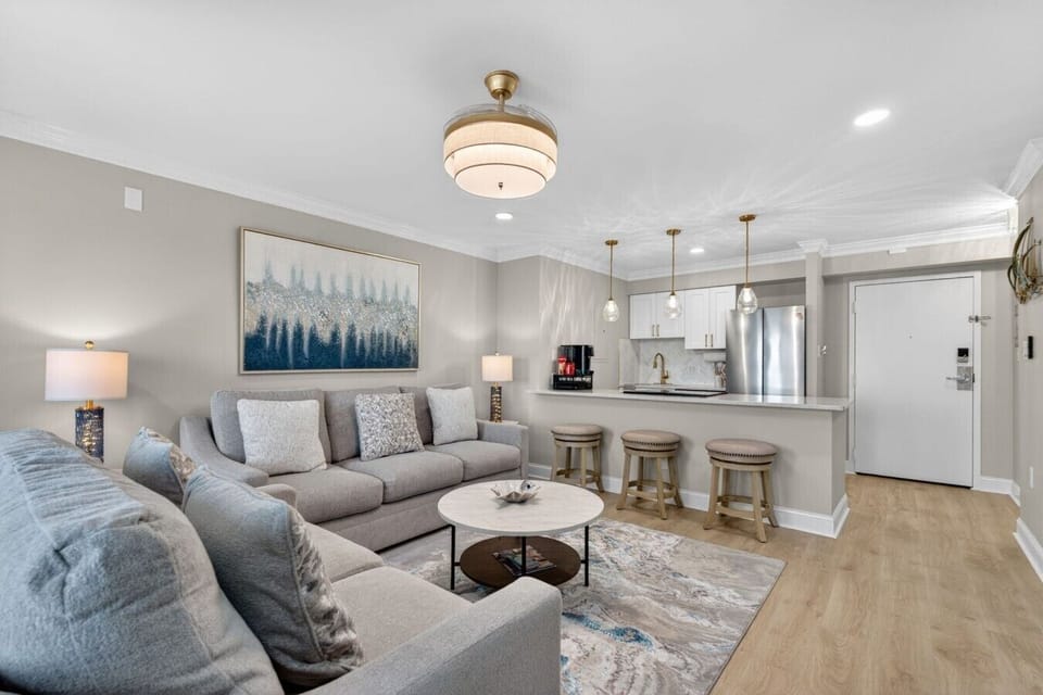 Unwind in the stylish living room while enjoying beautiful sunset views from the private balcony.