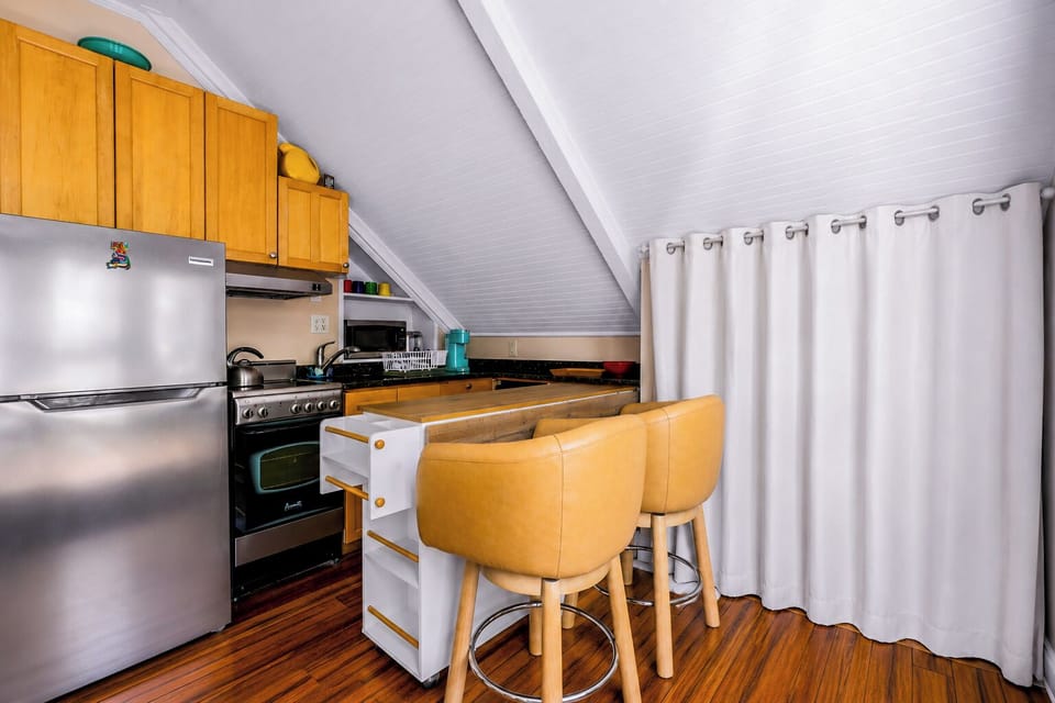 Cozy loft kitchenette with breakfast bar and stainless appliances