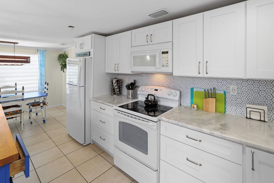 Bright modern kitchen with dining nook and stylish patterned backsplash