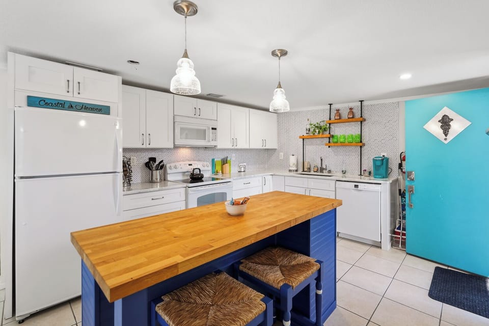 Bright coastal kitchen with large island seating and cheerful modern style