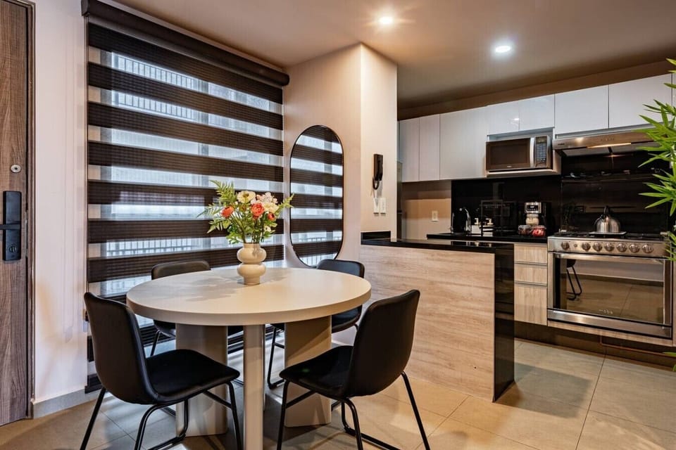 Round table for meals together, steps from a fully stocked kitchen.