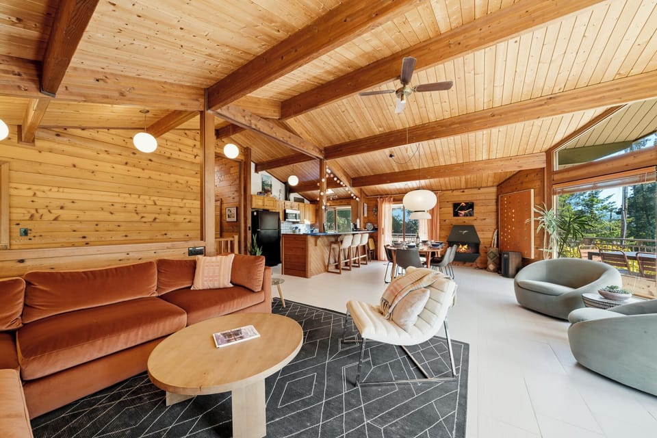Open living room with large comfy couch, Smart TV, Dining area, and open to the Kitchen.