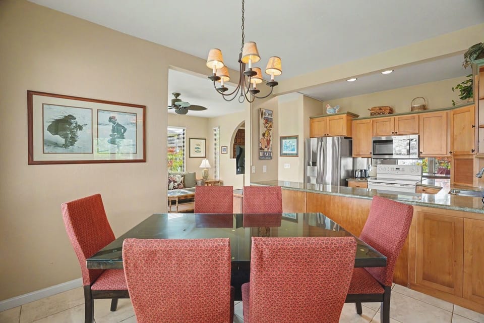 Gather around the stylish dining table where your group can share meals beneath elegant chandelier lighting, with the fully-equipped kitchen just steps away for effortless entertaining.