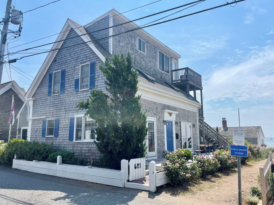 Front - condo is past stairs and primary bedroom is second set of french doors