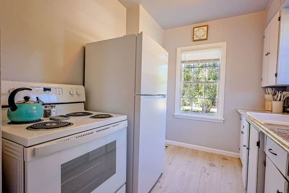 Bright, compact kitchen with full-size appliances and essentials for easy home-cooked meals