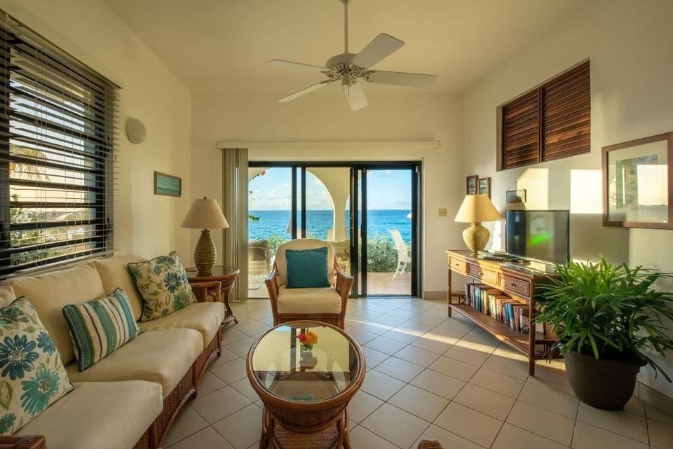 Lounge to ocean views as sunlight fills the room.