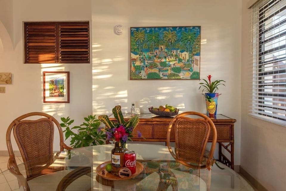 Gather for sunny breakfasts at the glass table and rattan chairs.