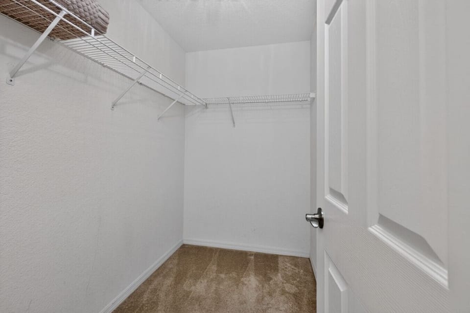 The spacious walk-in closet provides ample storage for clothing, luggage, and personal belongings, making it easy to unpack and settle in for an extended stay. Thoughtfully designed with generous shelving and hanging space, it offers the convenience of ho