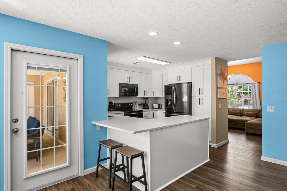 The heart of the villa. Whether you're whipping up a quick beach snack or brewing your morning cup, this open-concept kitchen keeps everyone part of the conversation. Grab a seat at the bar!