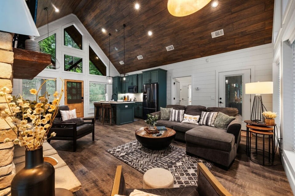 Open-concept living area with kitchen, dining, and vaulted ceiling.