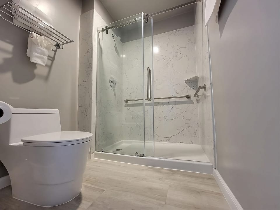 Unwind under a sleek glass shower with spa-like calm.
