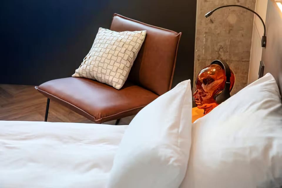 Unwind in crisp linens with stylish designer bedside touches.