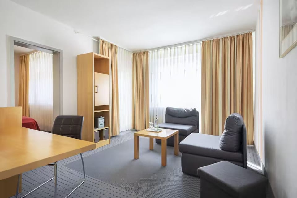 Unwind on the sofa as daylight pours through tall curtains.