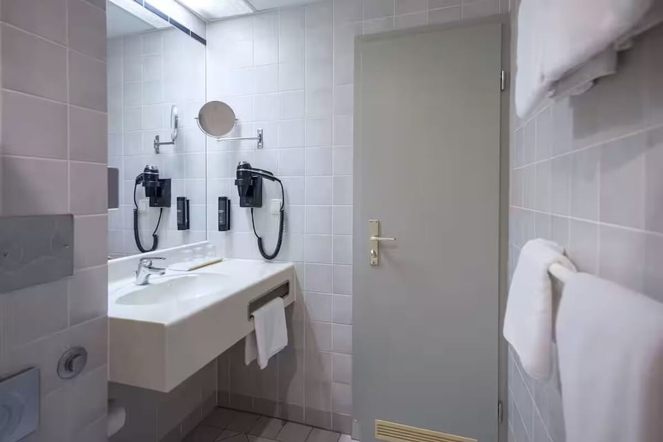 Refresh at the clean vanity with mirror and bright lighting.