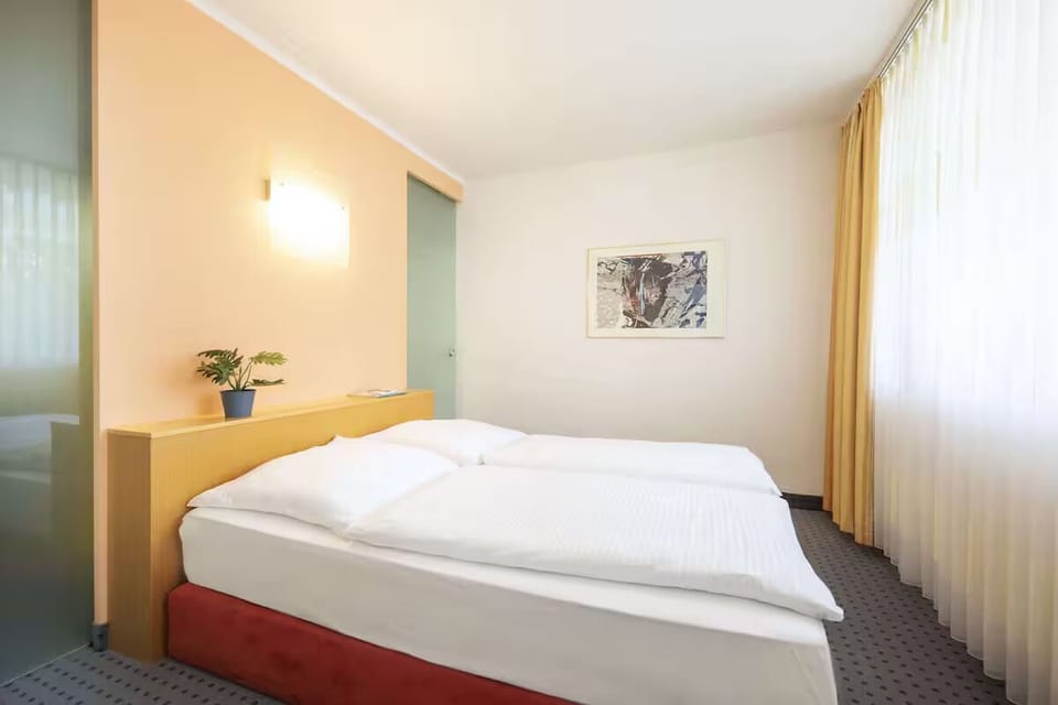 Unwind in a bright bedroom with plush, crisp linens.