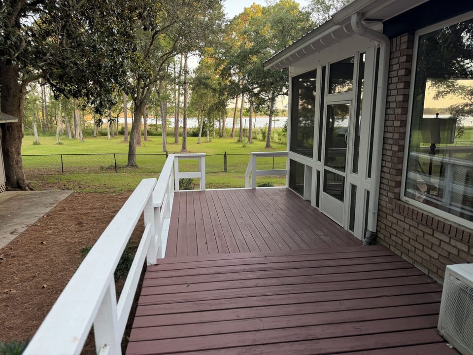 Spacious backyard deck with peaceful tree-lined views