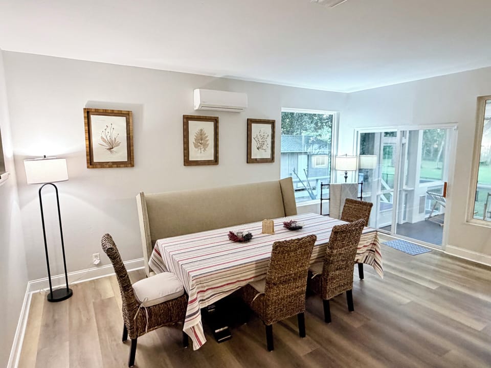 Bright dining area with patio access and stylish coastal touches