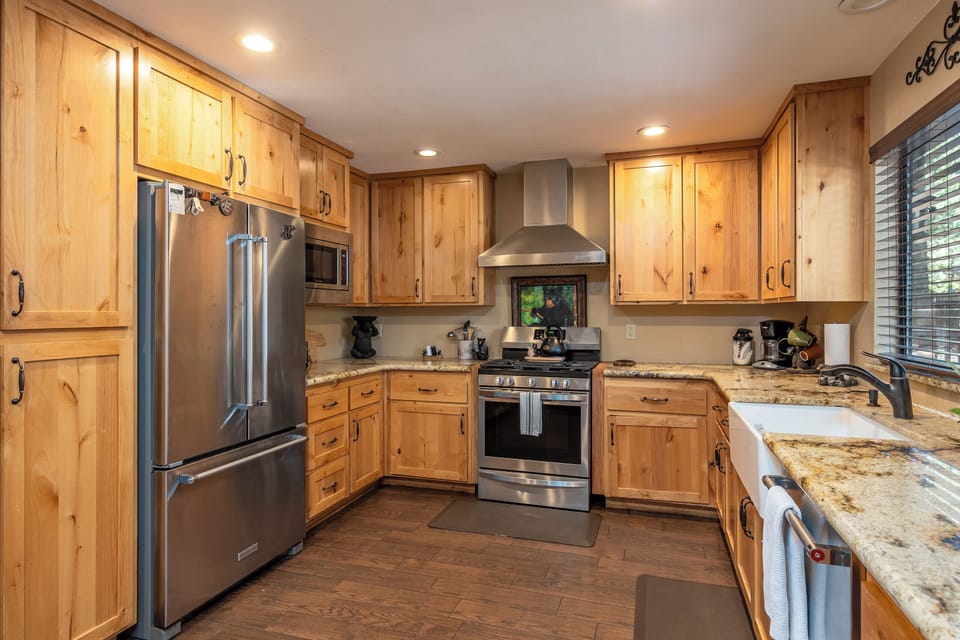 Your fully equipped kitchen features warm pine cabinetry, granite countertops, stainless appliances, and a gas range—everything you need to prepare meals like home.
