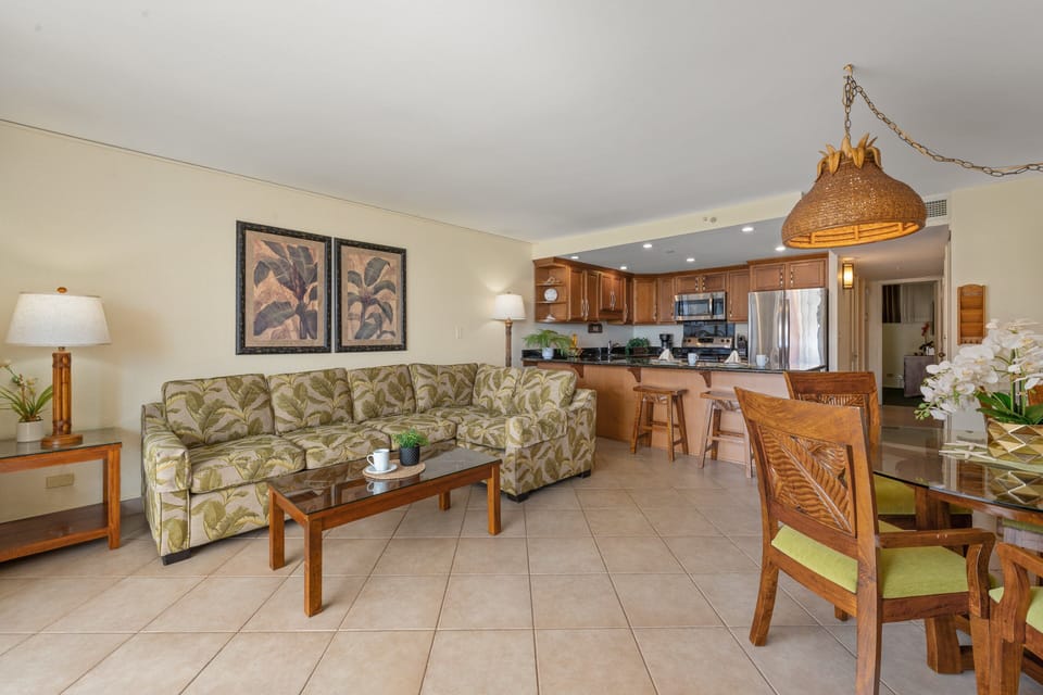 Open concept living room flowing into dining area and full kitchen.