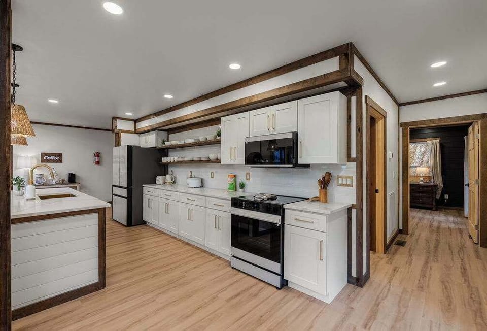 Custom White Countertops and Beautiful Appliances. Enough Cookware for Chefs!