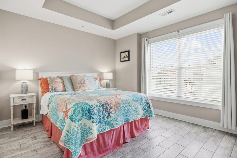 This spacious bedroom features a comfortable queen bed and an ensuite bathroom.