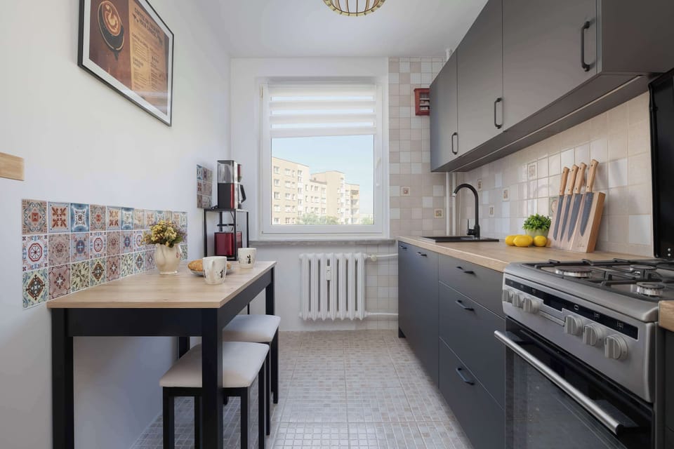 The kitchen's contemporary decor complements the apartment's style.
