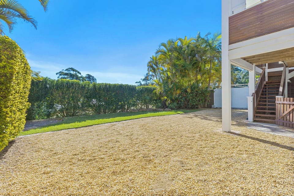 Sunny private courtyard with tropical landscaping and easy home access