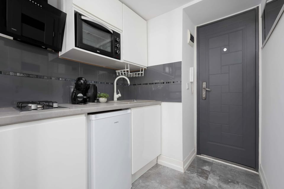 Well-equipped kitchenette with a coffee maker, and storage space.