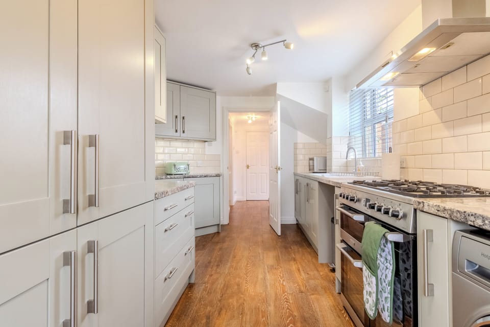 Bright modern kitchen with gas range, ample storage, and natural light