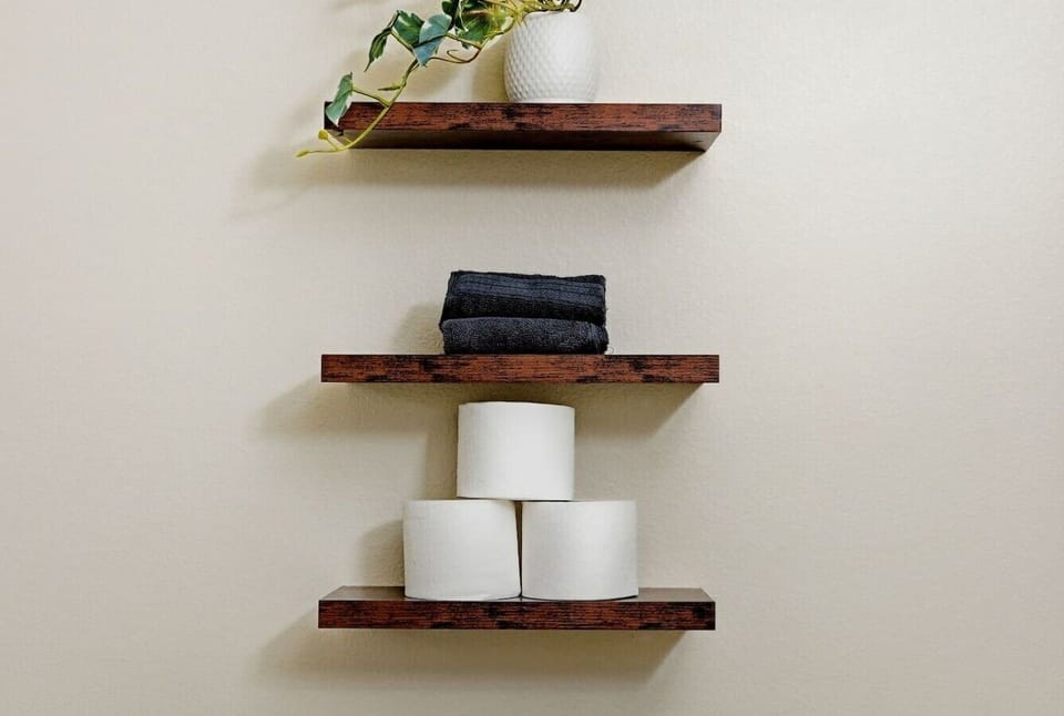Floating wood shelves stocked w/ towels for easy access