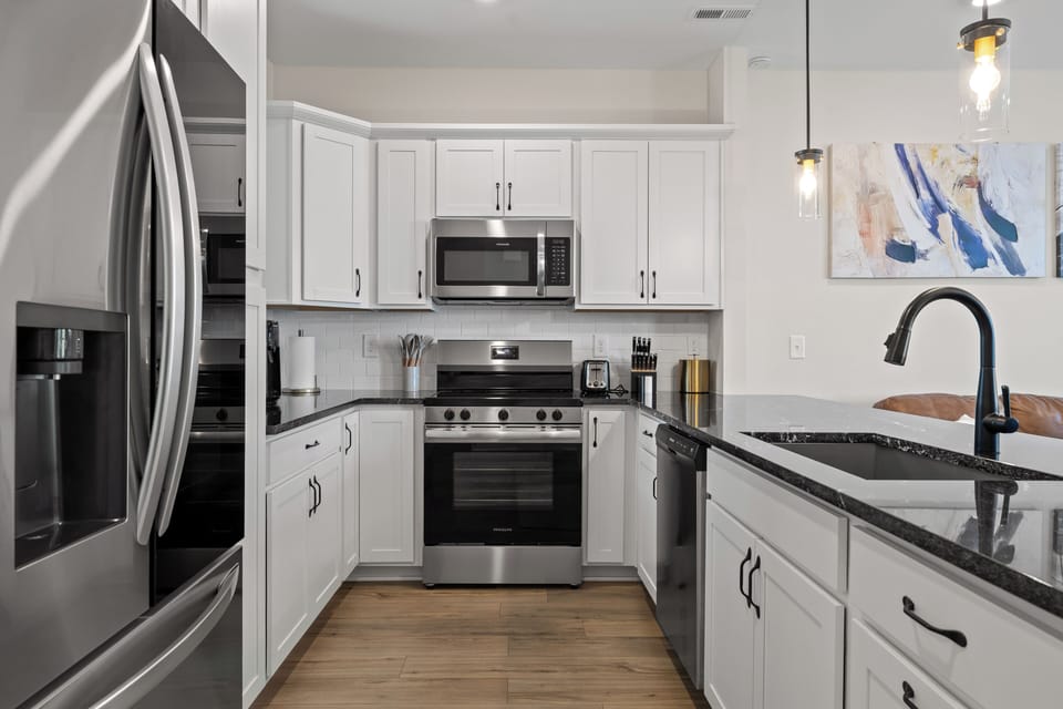 Bright modern kitchen with island, stainless appliances, and stylish finishes