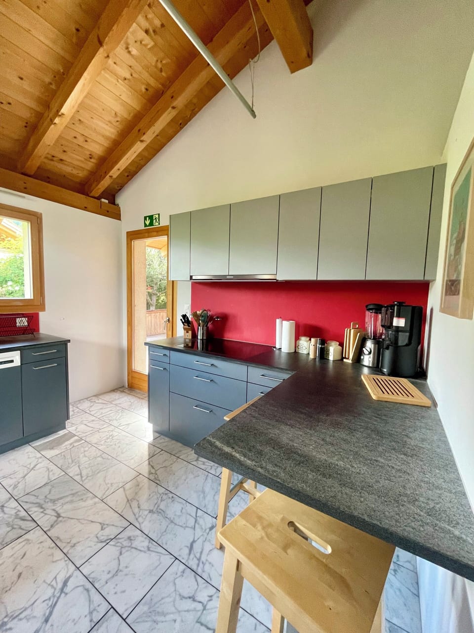 Bright modern kitchen with vaulted wood ceilings and breakfast bar