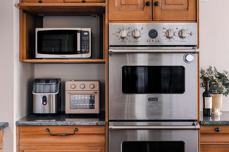 Well-equipped kitchen with stainless oven, microwave, and handy small appliances