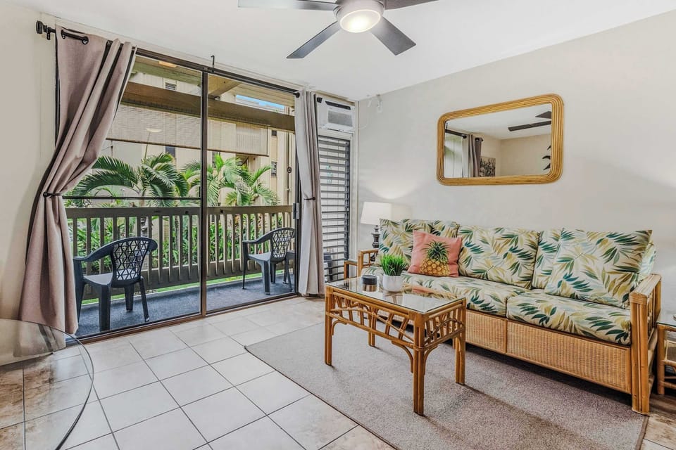 Bright living room with tropical décor and direct access to the lanai.
