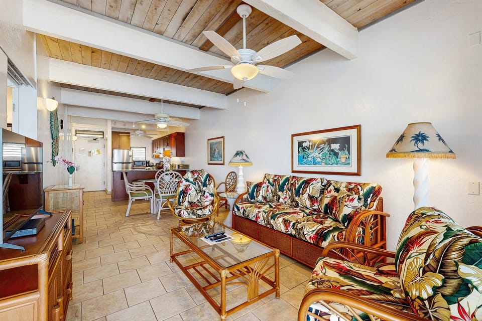 Open Living Room with Vaulted Ceilings, Wooden Beams, Ceiling Fan, and Ample Seating