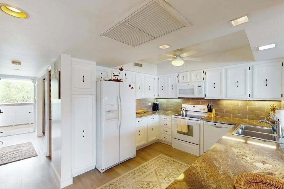 Bright Kitchen Angle Highlighting Prep Counter & Full-Sized Refrigerator