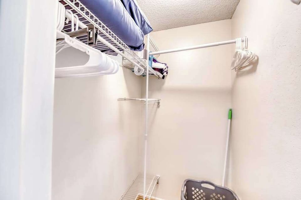 Walk-In Closet Space with Wire Shelving & Laundry Accessories