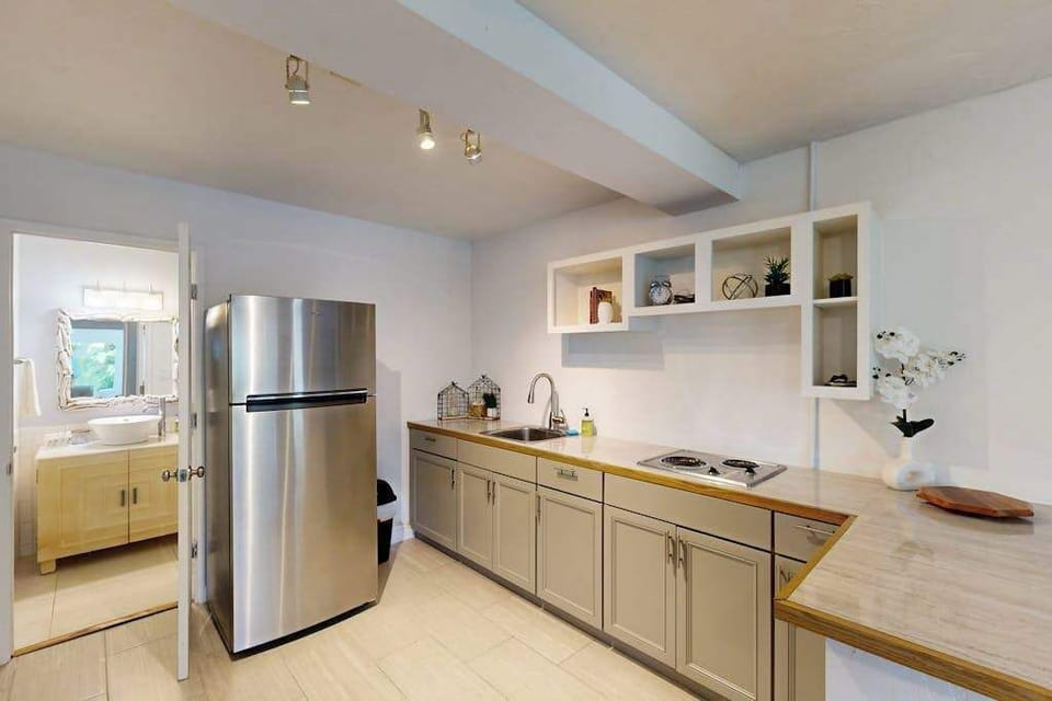 Well equipped kitchen features stainless appliances cabinetry and counter space