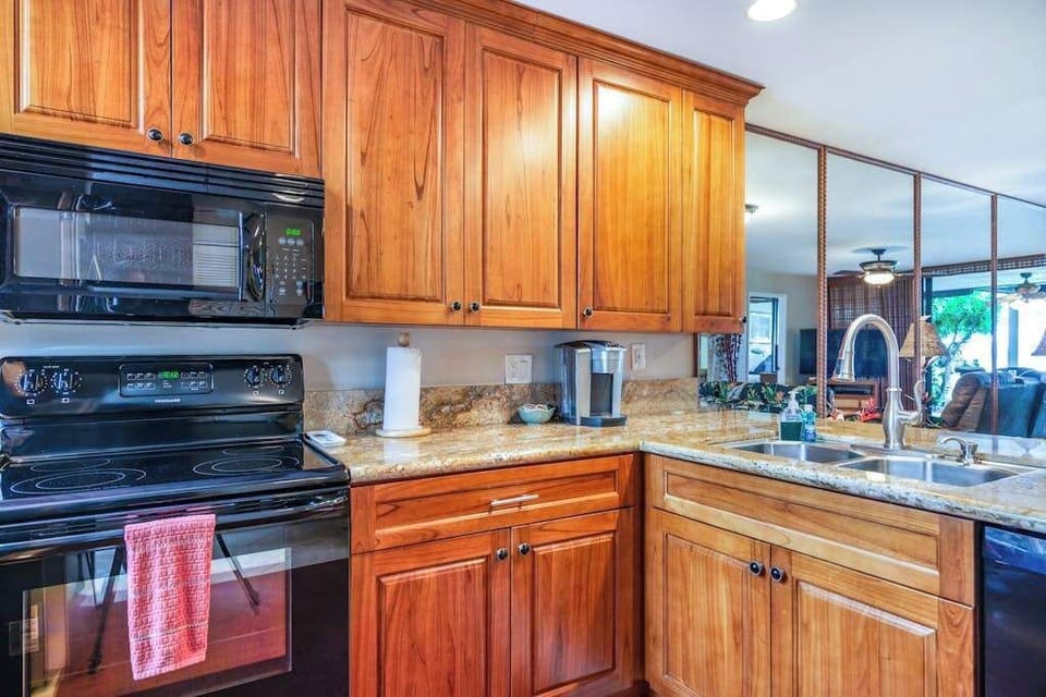 Fully Equipped Kitchen with Wood Cabinetry & Modern Appliances