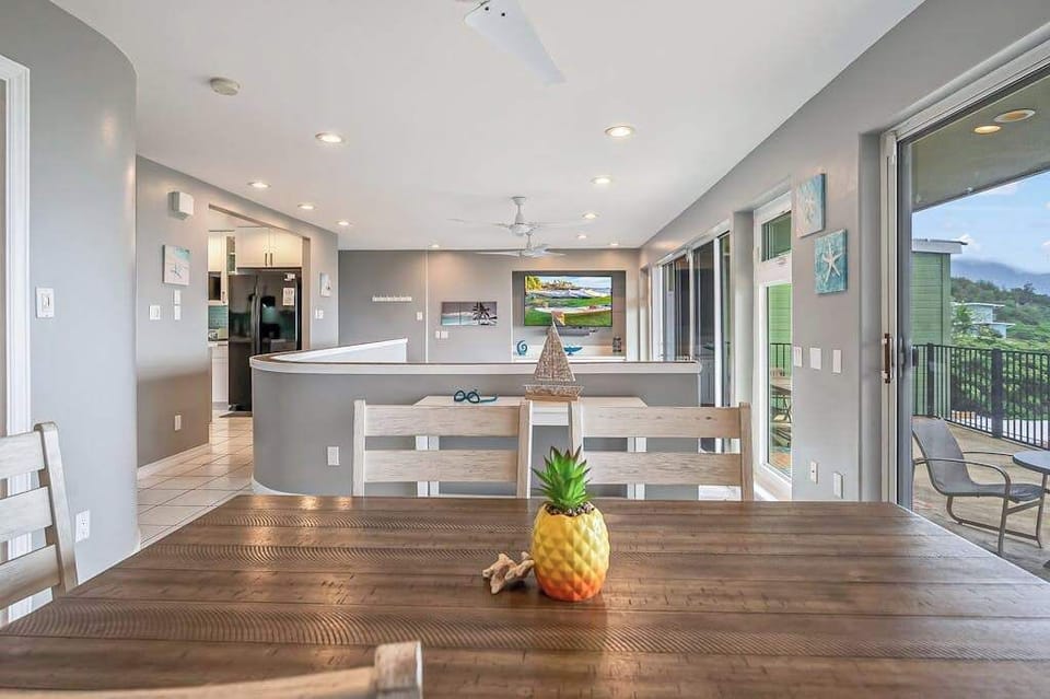 Bright, open-concept living with floor-to-ceiling doors that seamlessly blend indoor comfort with stunning tropical ocean views