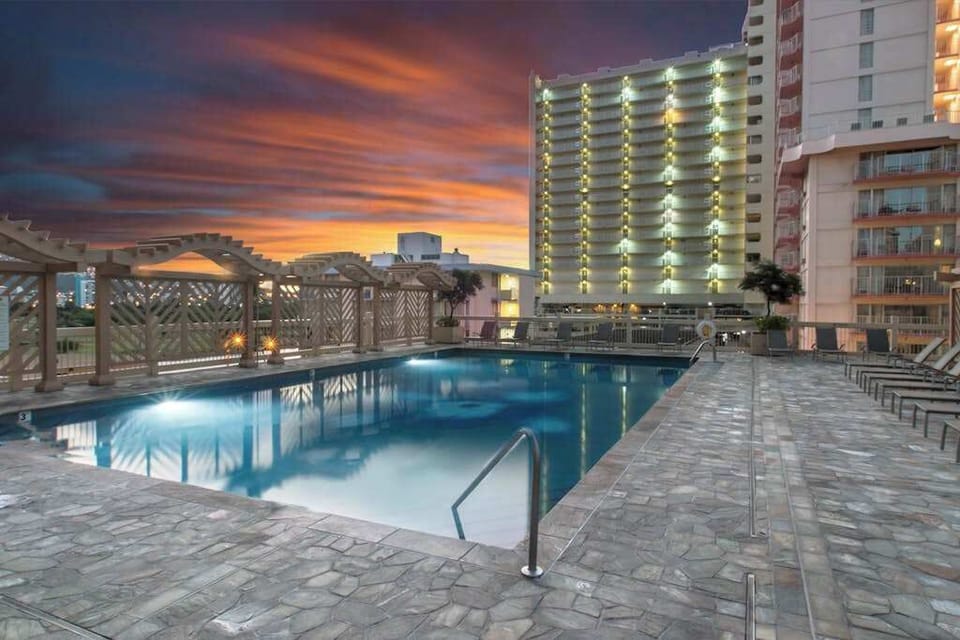 Enjoy a refreshing swim in the shared resort pool, perfect for relaxing under the sun.